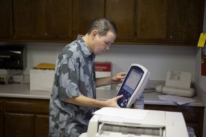 Rob using a copy machine at the office