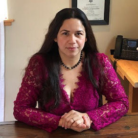 Luz Chavez sitting at a desk