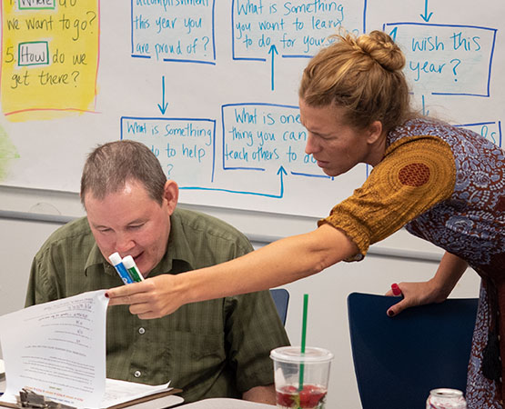 JNCS staff explaining something to a student