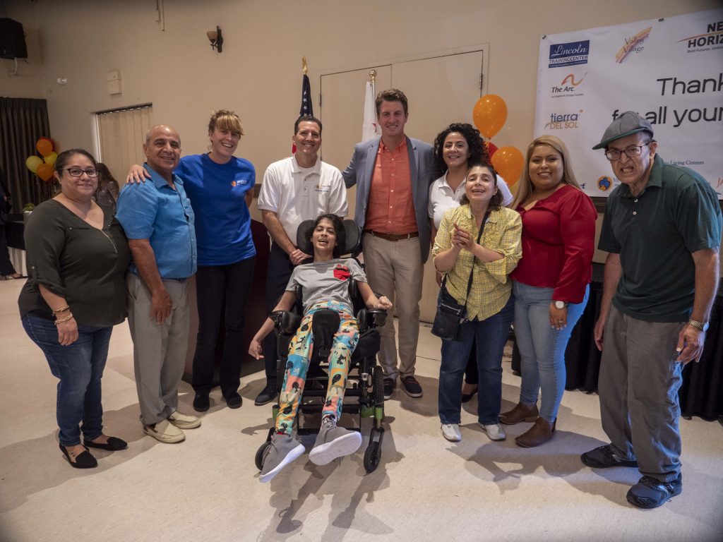 JNCS supported individuals and staff posing for a group photo with Senator Henry Stern at a thank you luncheon