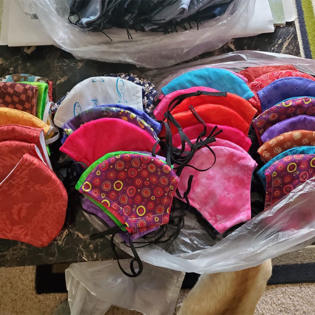 A selection of homemade face masks sewed by a supported individual