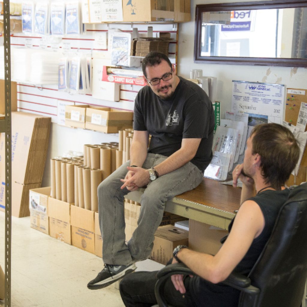 Two staff discussing something at a shipping and container store