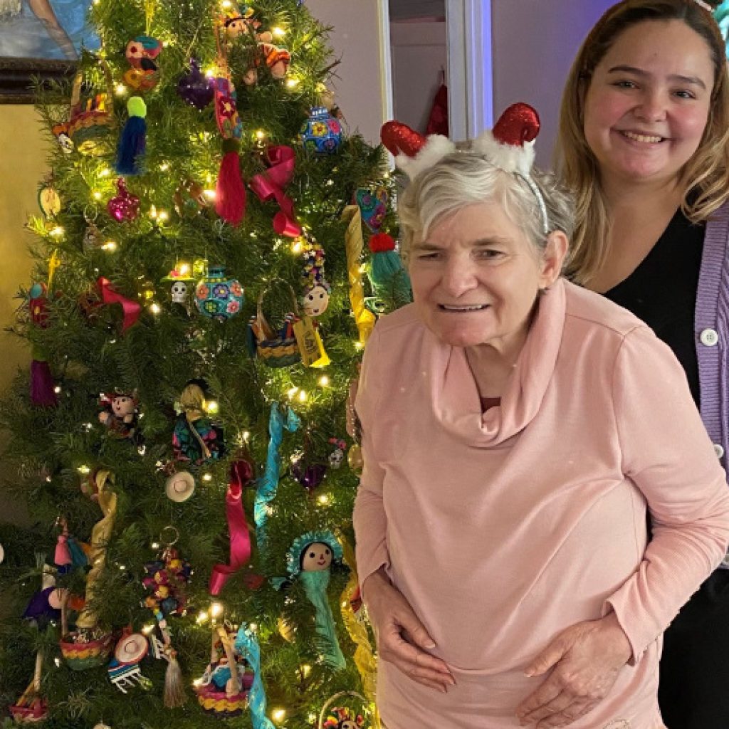 Glos and serenity standing next to a Christmas tree