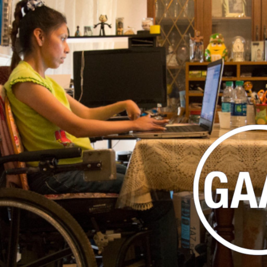Woman in a wheelchair working on a laptop, with GAAD (Global Accessibility Awareness Day) logo overlaid