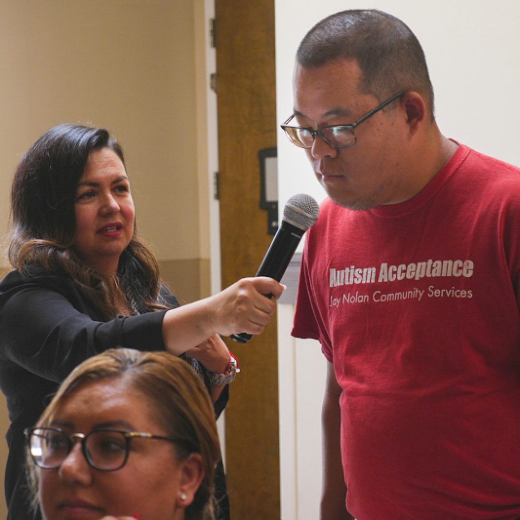 A self-advocate makes a statement during a town hall meeting