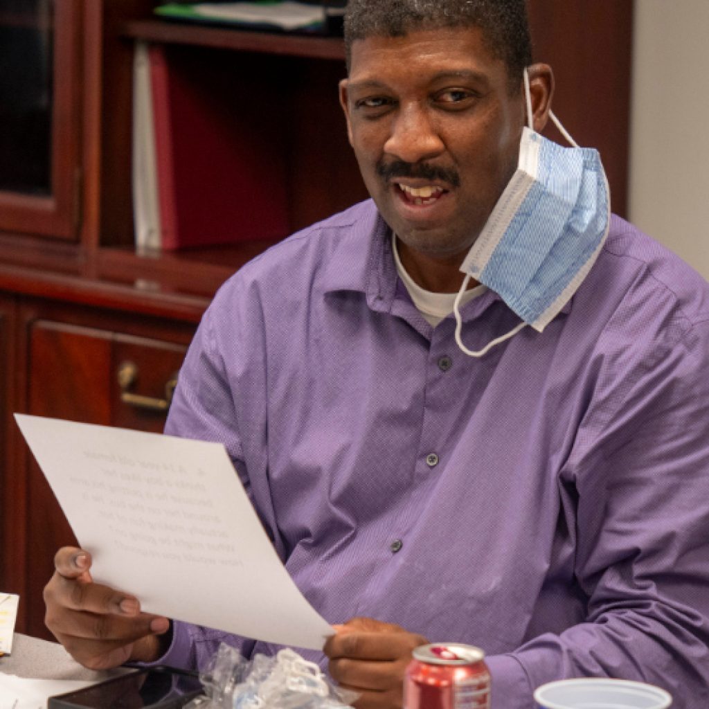 Self-Advocate Wesley Witherspoon holds up a training documents during a class.