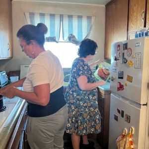 Marisol and Ilene cooking dinner