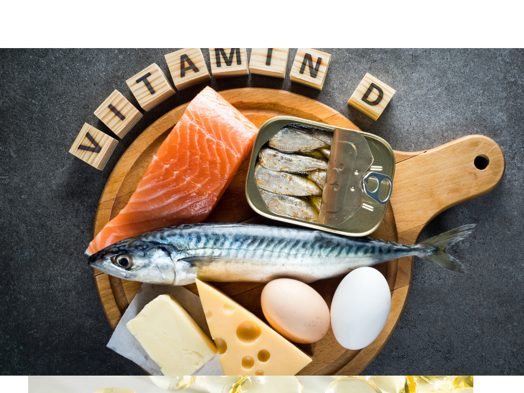 An array of vitamin D rich foods on a cutting board including fish, eggs, and cheese. Text reads "VITAMIN D"