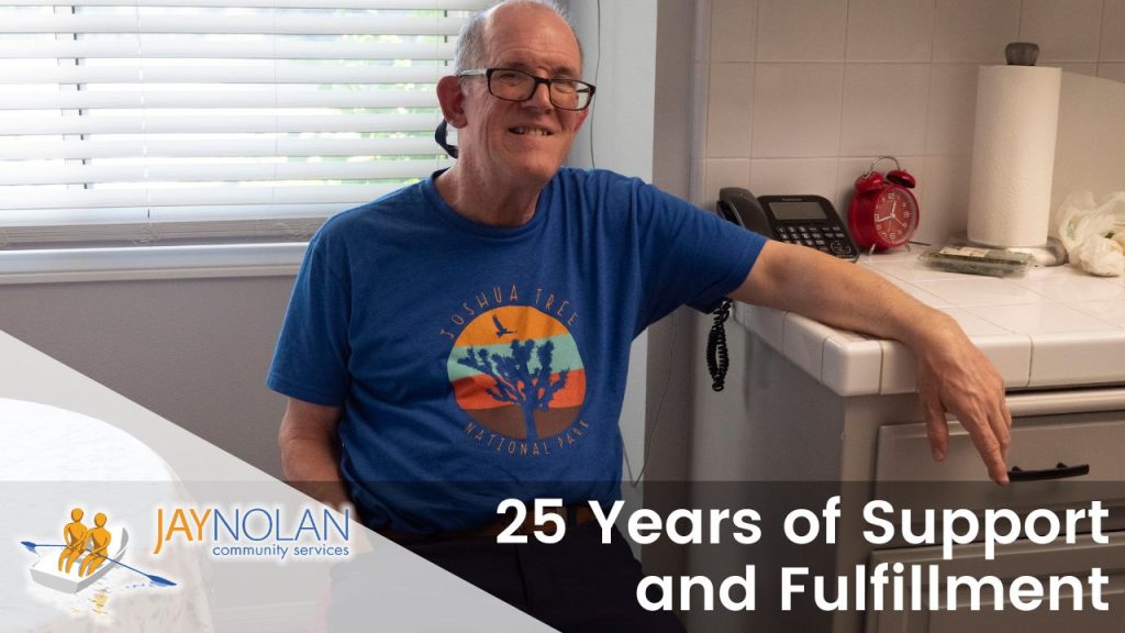 Video Thumbnail depicting Dan, an older caucasian man wearing a dark blue t-shirt, sitting in his kitchen. Text Reads: "25 Years of Support and Fulfillment"