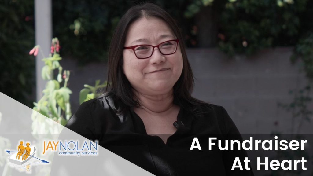 Video Thumbnail featuring an asian woman wearing a black shirt. Text reads: "A Fundraiser At Heart"