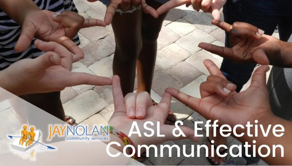 Video thumbnail featuring a group of people standing in a circle and signing the ASL sign for love to each other. Text reads: ASL & Effective Communication"