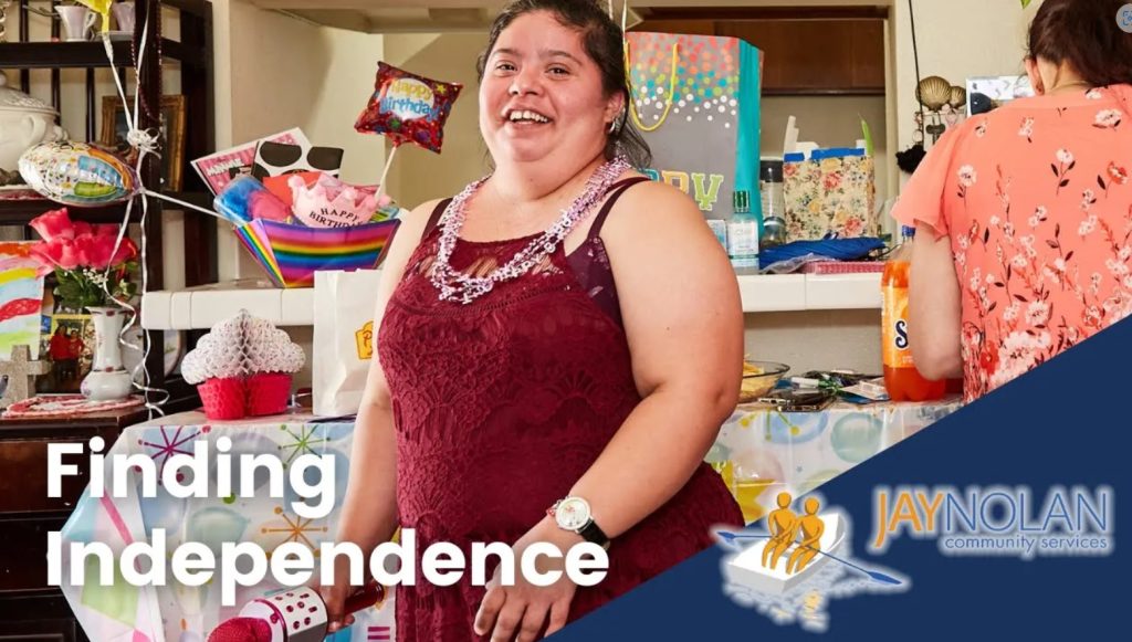 Video thumbnail featuring a latino woman in a red dress surrounded by birthday gifts. Text reads: Finding Independence