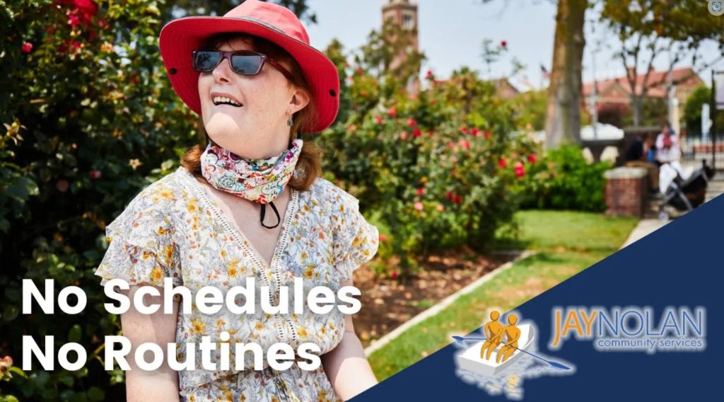 Video thumbnail featuring a Caucasian woman wearing a floral dress and a bright red hat. She is standing in a rose garden. Test reads: "No Schedules No Routines"