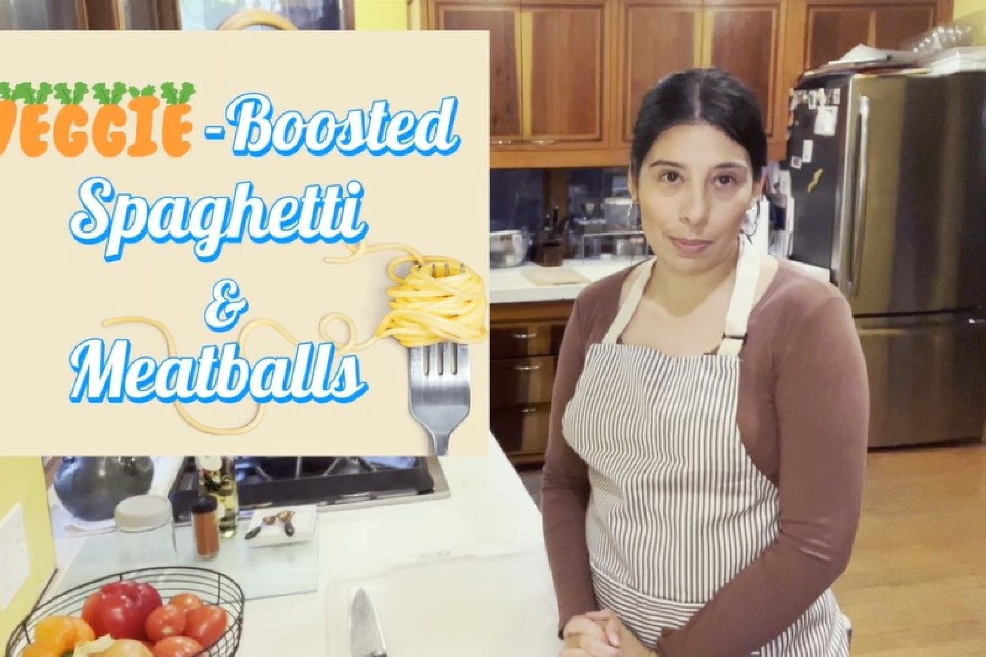 Thumbnail for a recipe video with woman with dark hair wearing and striped apron standing in a kitchen. Text reads: "Veggie-Boosted Spaghetti and Meatballs"