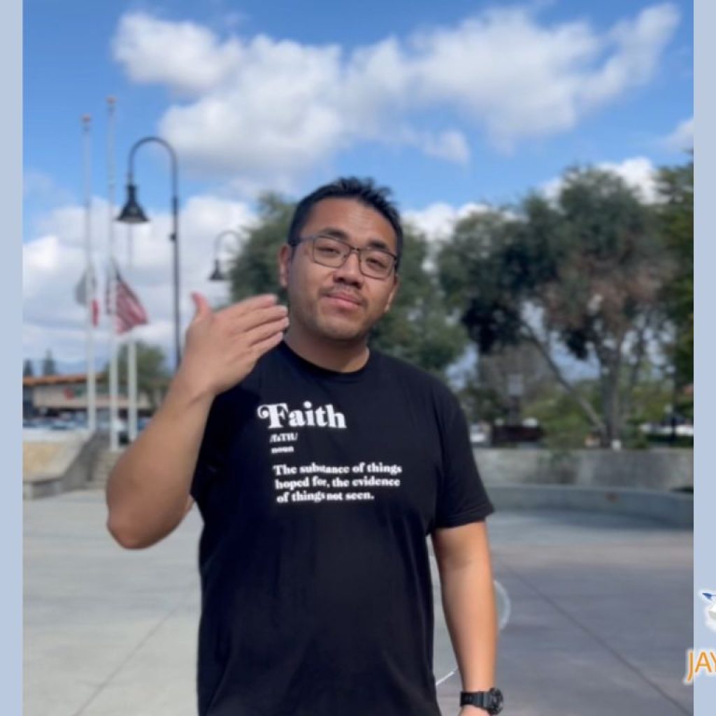 A Hispanic young male with black hair wearing a black t-shirt.