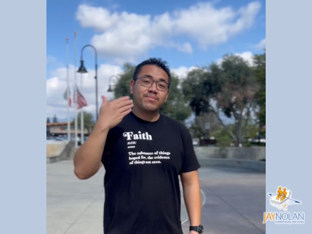 A Hispanic young male with black hair wearing a black t-shirt.
