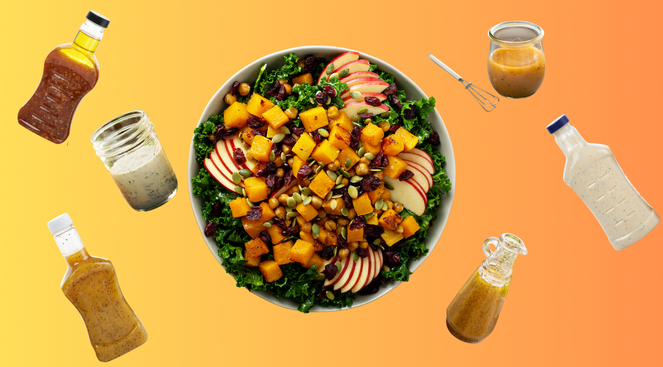 1 bowl of kale salad with squash, apple slices, cranberries and seeds surrounded by various salad dressings on orange background