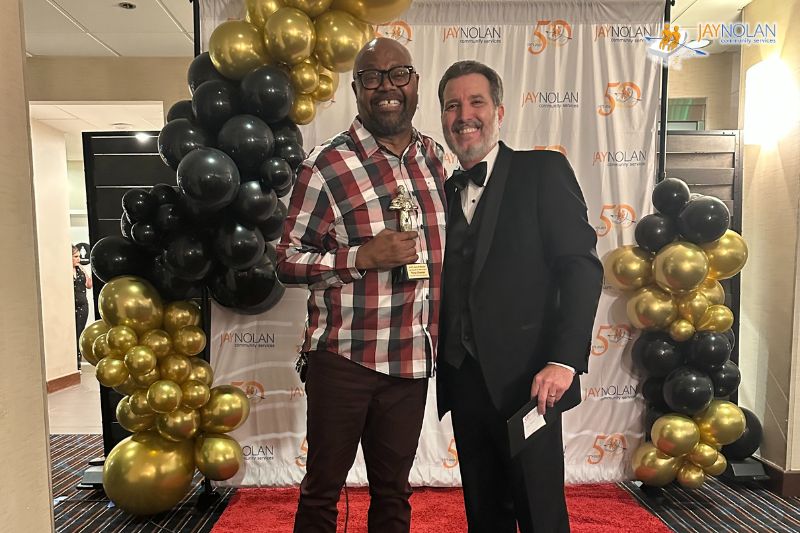 Jay Nolan Supervisor Tony Chester posing with the Jay Nolan CEO while holding a Key Results Award trophy.