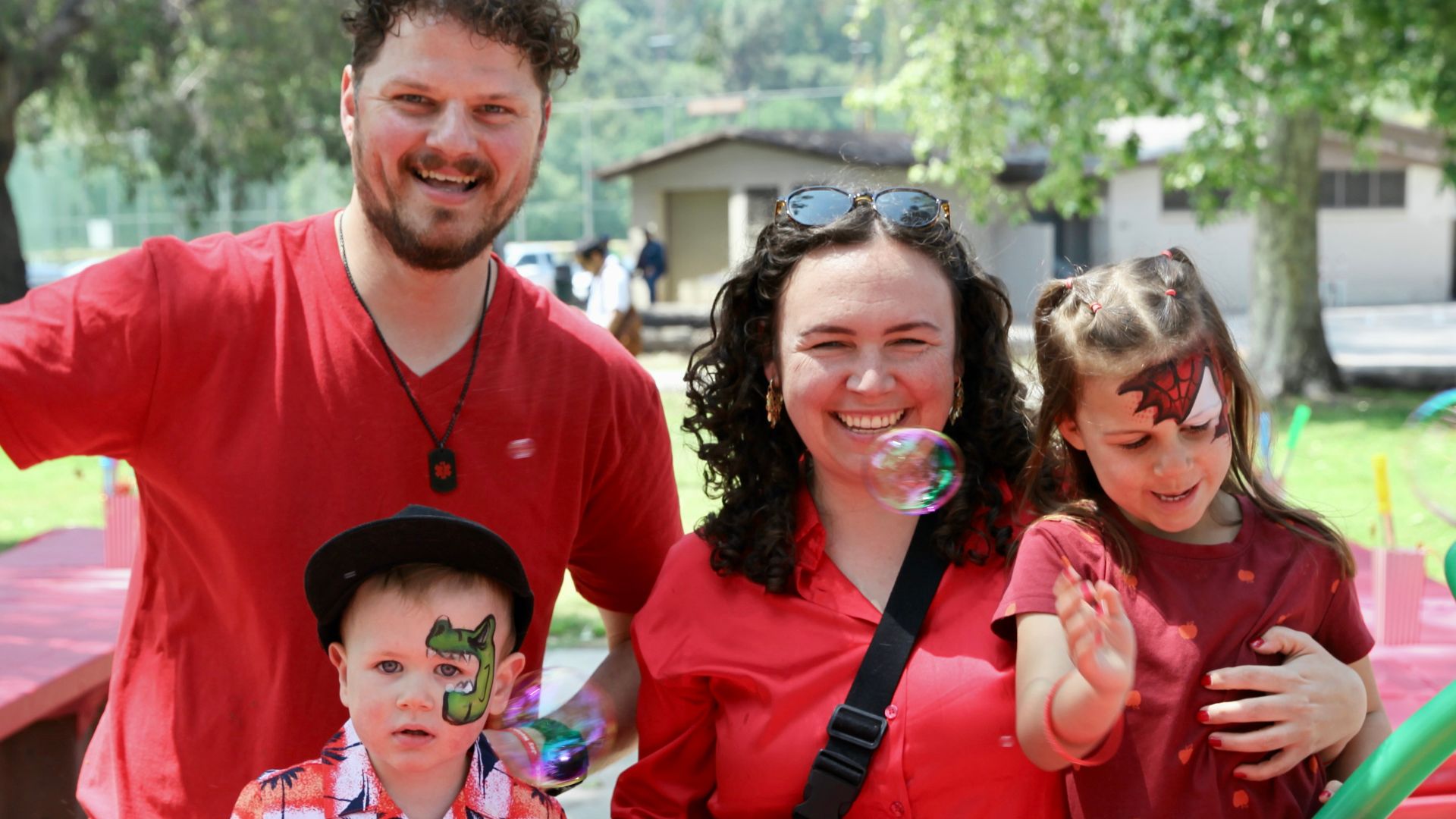 Family with two kids all wearing red to celebrate Autism Acceptance Month.