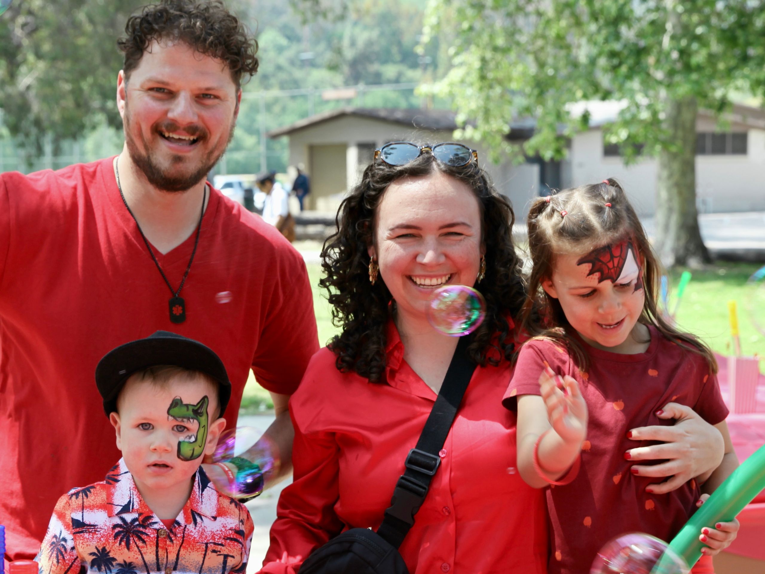 Family with two kids all wearing red to celebrate Autism Acceptance Month.