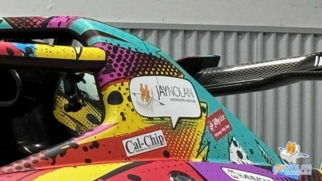 Close up of Racing with Autism's 2026 racecar with the Jay Nolan Community Services logo on it as a sponsor
