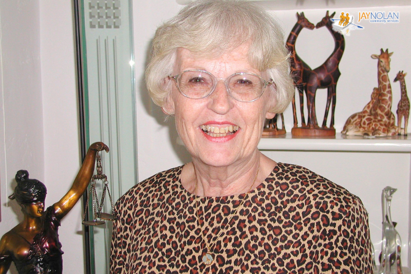 Portrait of Toby Arenberg: A smiling Caucasian woman with short curly white hair.